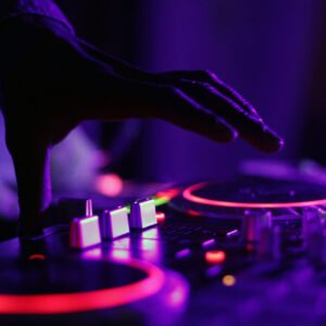 DJ turntables in purple and pink nightclub lighting